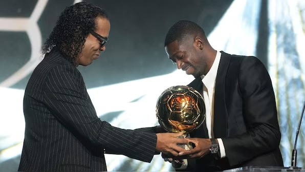 Ballon d'Or 2025 winner Ousmane Dembele receives the trophy from Ronaldinho