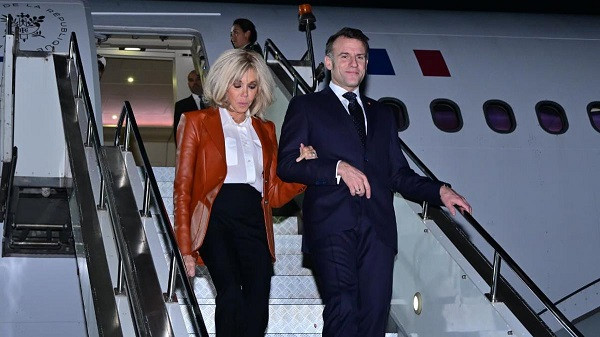 France President Emmanual Macron, with his wife Brigette, arrive in Mumbai