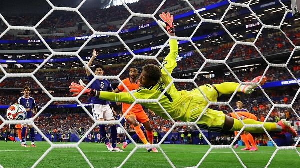 Netherlands' Virgil van Dijk scores their first goal past Japan's Zion Suzuki