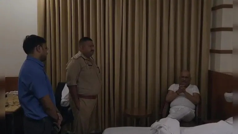 Police with Ajay Rai inside his hotel room in Ayodhya